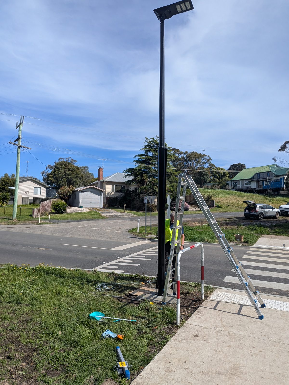 Plusrite 6 metre hinged light pole with a solar area light, installed beside a footpath